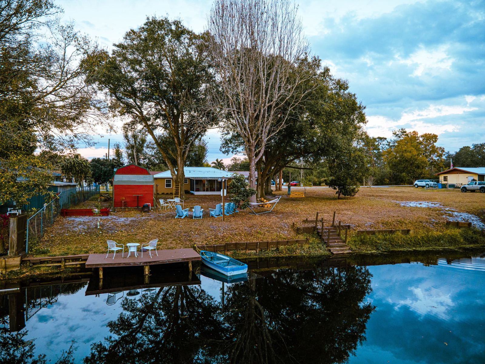 Aerial view of the backyard, private dock, and canal leading to Lake Clay