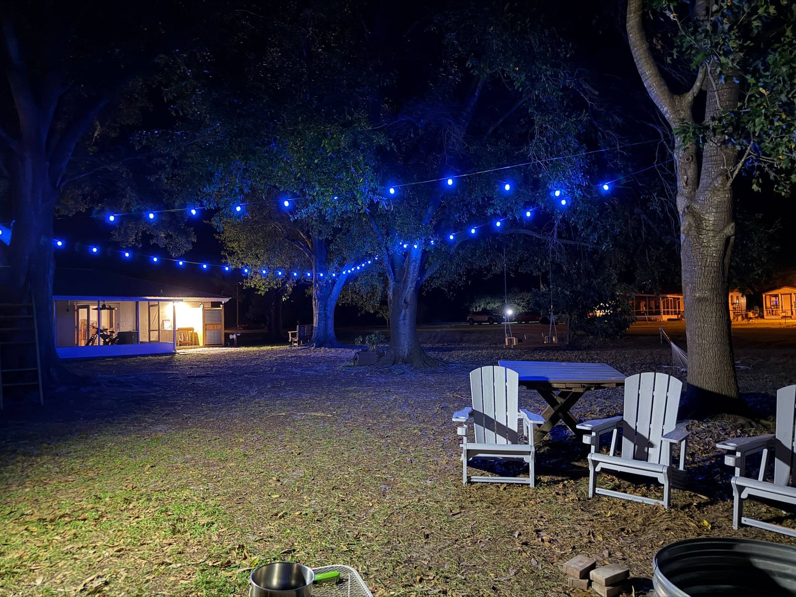 Backyard at night glowing with color-changing smart string lights